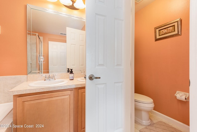 bathroom with toilet, an enclosed shower, vanity, and tile patterned floors