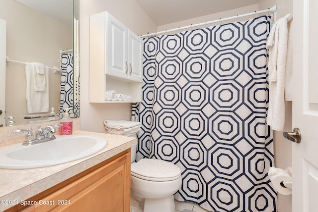 bathroom featuring vanity, toilet, and a shower with shower curtain