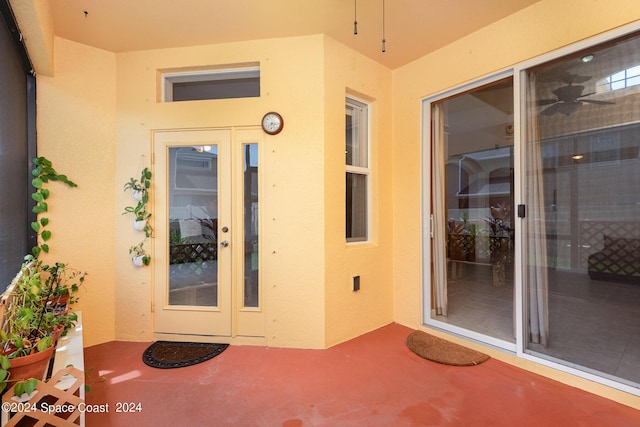 property entrance with stucco siding