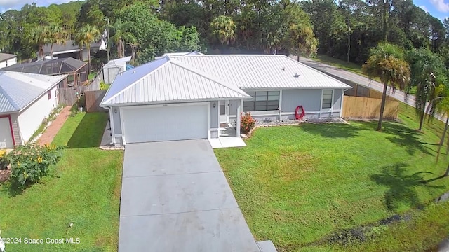 view of front of property with a garage and a front lawn