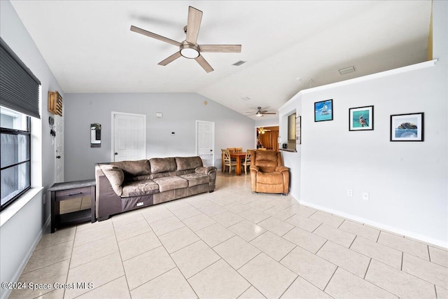 living room featuring ceiling fan, light tile patterned flooring, and vaulted ceiling