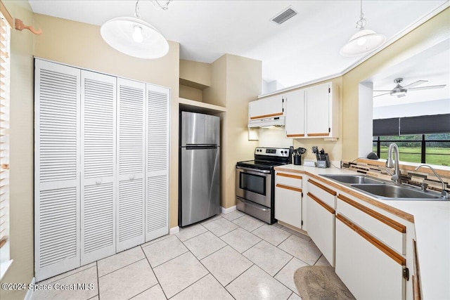 kitchen with appliances with stainless steel finishes, sink, ceiling fan, pendant lighting, and white cabinets