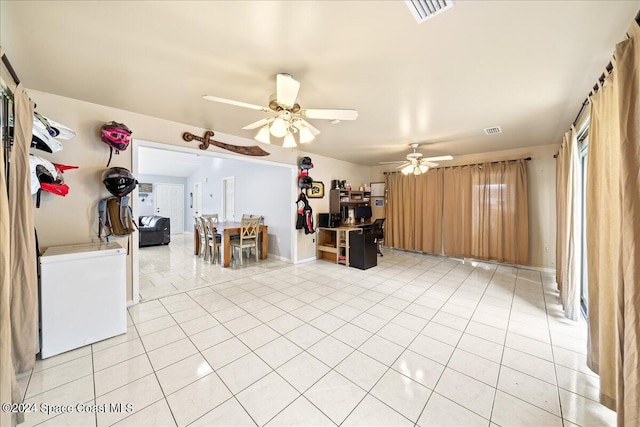 interior space featuring light tile patterned floors and ceiling fan