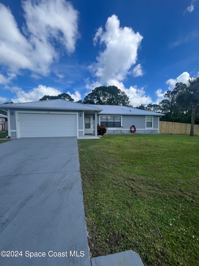 single story home featuring a front yard and a garage