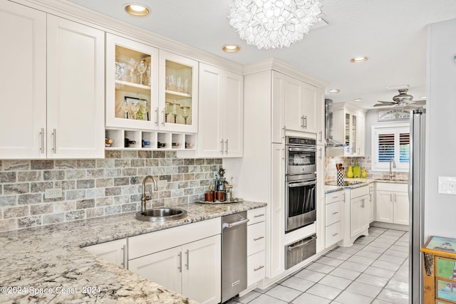 kitchen featuring stainless steel double oven, white cabinets, a sink, and a warming drawer