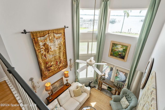 living room featuring a water view, ceiling fan, and hardwood / wood-style flooring