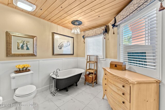 bathroom with toilet, a washtub, and wooden ceiling