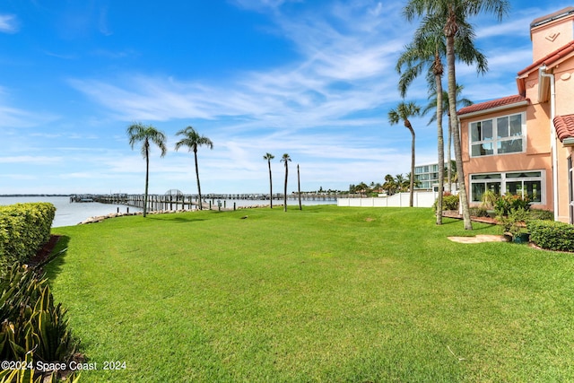 view of yard featuring a water view and fence