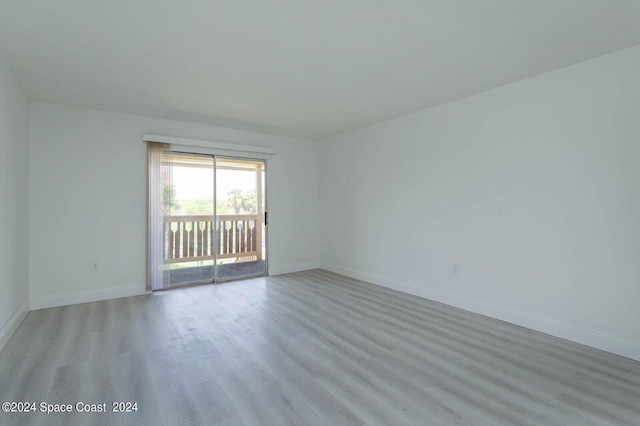 empty room with light hardwood / wood-style flooring