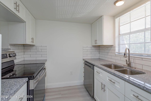 250 Berkshire Ln, Melbourne, FL 32935 - kitchen featuring appliances with stainless steel finishes, baseboards, a sink, and light stone counters