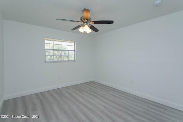 spare room featuring wood-type flooring and ceiling fan