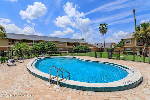 250 Berkshire Ln, Melbourne, FL 32935 - community pool featuring a yard, fence, and a residential view