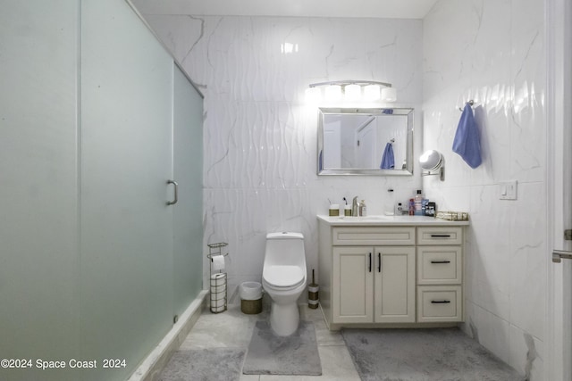 bathroom featuring toilet, a shower with shower door, and vanity