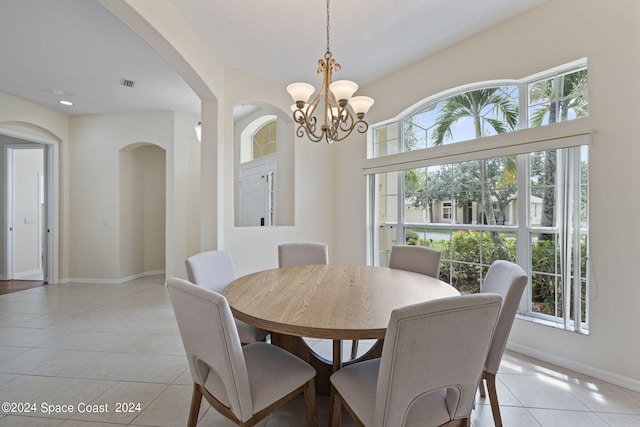 tiled dining area with a chandelier