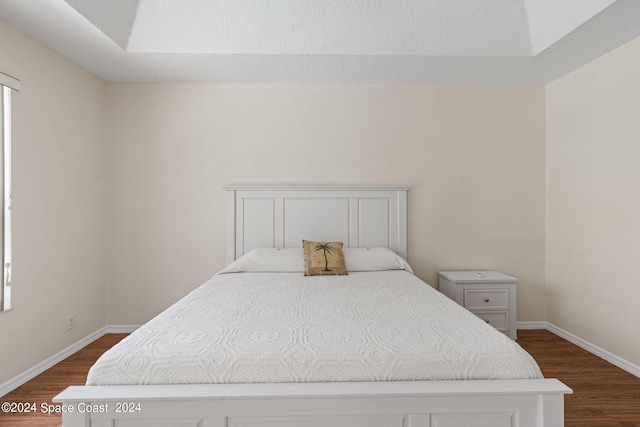 bedroom with dark hardwood / wood-style floors