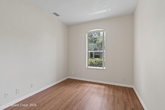 empty room featuring hardwood / wood-style flooring