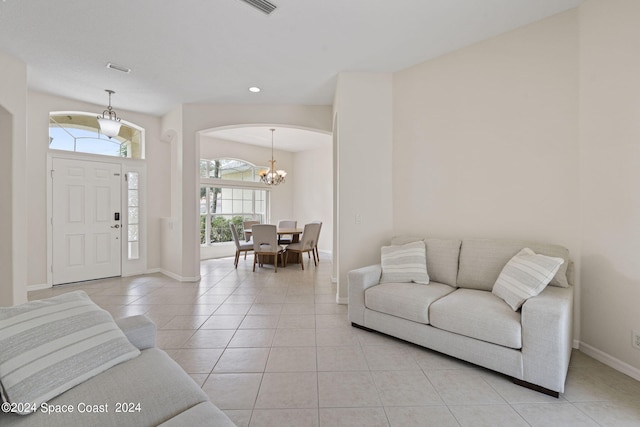 living room featuring an inviting chandelier and light tile patterned floors