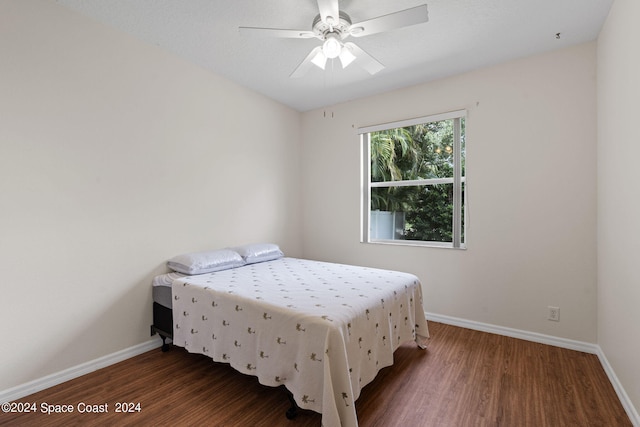 bedroom with ceiling fan and dark hardwood / wood-style floors