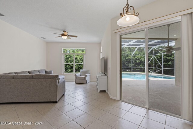 living room featuring ceiling fan and light tile patterned floors