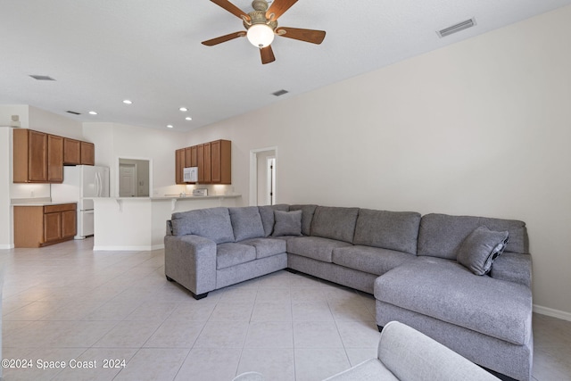 tiled living room featuring ceiling fan