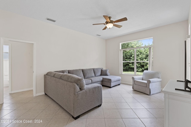 tiled living room featuring ceiling fan