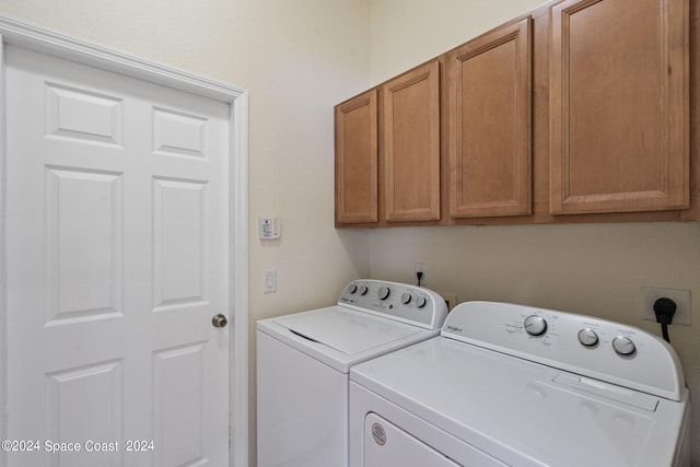 laundry room with cabinets and separate washer and dryer