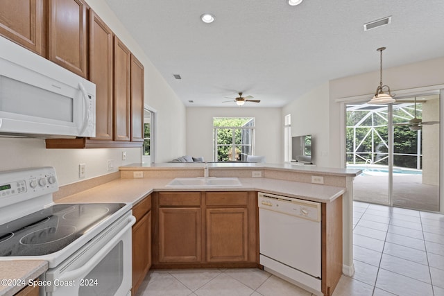 kitchen featuring hanging light fixtures, white appliances, sink, kitchen peninsula, and ceiling fan