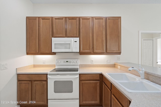 kitchen featuring sink and white appliances