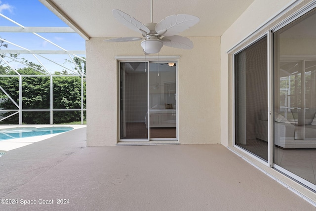 view of patio featuring ceiling fan and a lanai