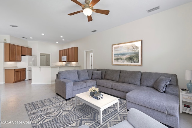 tiled living room with ceiling fan