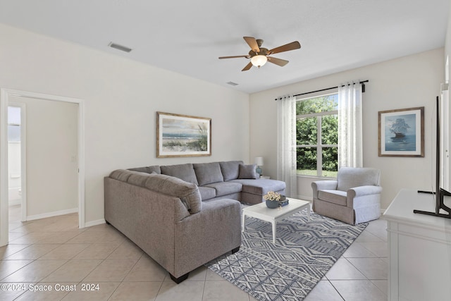 tiled living room with ceiling fan