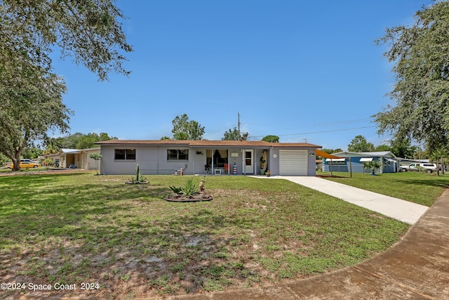 ranch-style home featuring a front yard and a garage