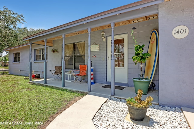 exterior space featuring a porch and a lawn