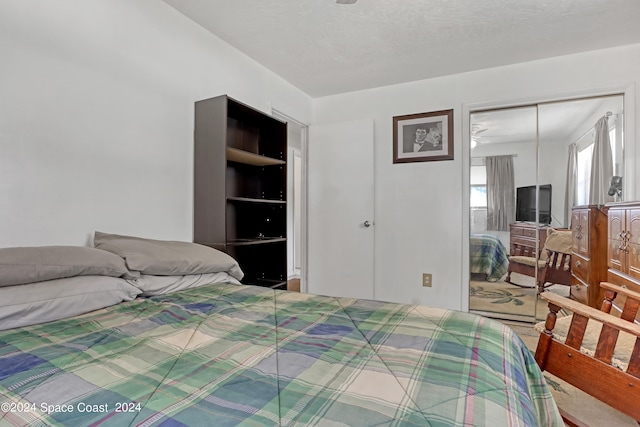 bedroom featuring a closet and a textured ceiling