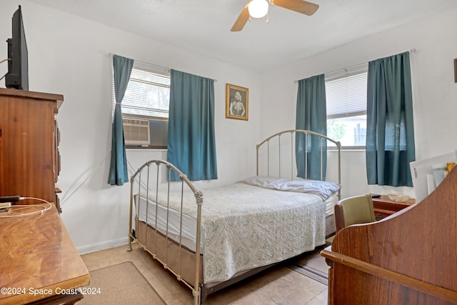 bedroom featuring ceiling fan and multiple windows