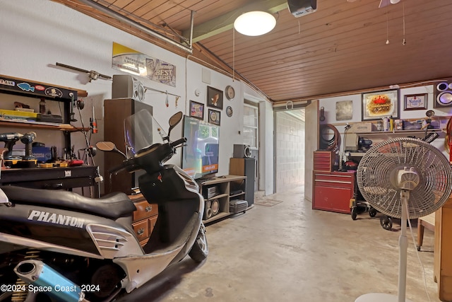 garage with wood ceiling and a workshop area