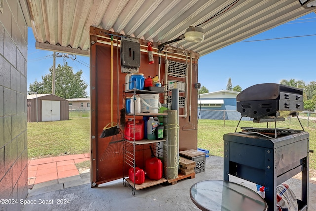 view of patio with ceiling fan and a shed