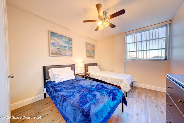 bedroom featuring light hardwood / wood-style flooring and ceiling fan