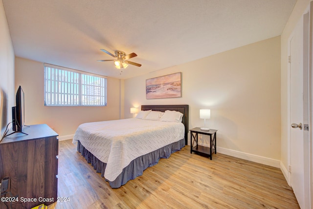 bedroom with ceiling fan and light wood-type flooring