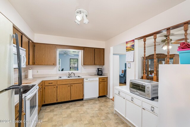 kitchen featuring ceiling fan, sink, light tile patterned floors, and white appliances