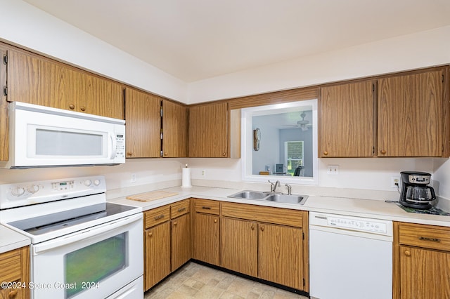 kitchen featuring sink, white appliances, and light tile patterned flooring