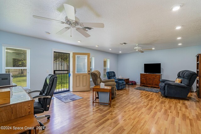 home office featuring ceiling fan, a textured ceiling, and light hardwood / wood-style flooring