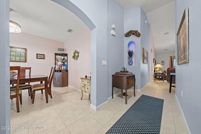 hall featuring light tile patterned floors