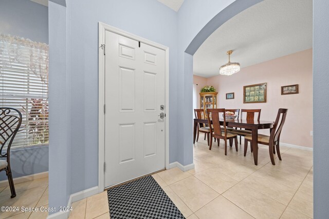 tiled foyer with a healthy amount of sunlight