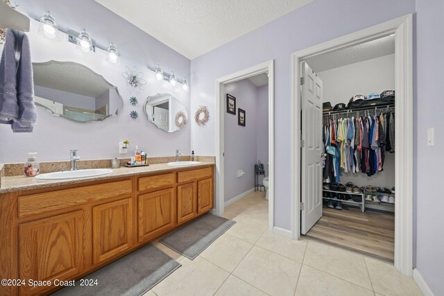 bathroom featuring vanity, a textured ceiling, and wood-type flooring