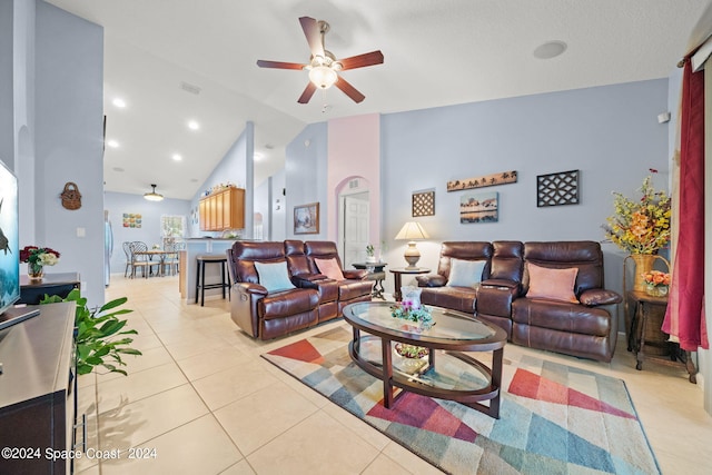 tiled living room with high vaulted ceiling and ceiling fan