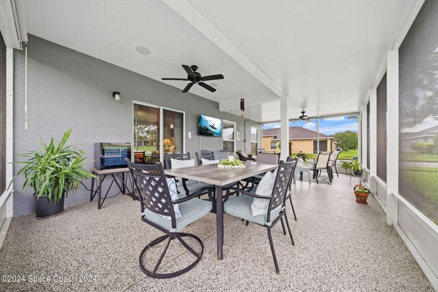 sunroom featuring ceiling fan