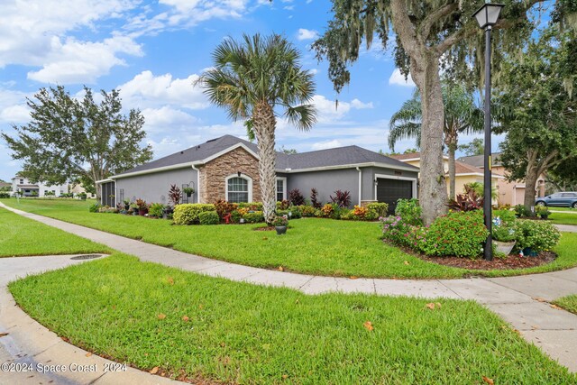 single story home with a garage and a front yard