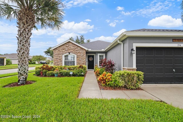 single story home featuring a garage and a front lawn