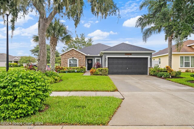 single story home with a front lawn and a garage